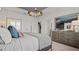 Beautiful main bedroom features a decorative light fixture, neutral paint, and ensuite bathroom at 15113 Grove Lake Dr, Winter Garden, FL 34787