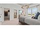 Comfortable main bedroom boasting a walk-in closet, ensuite bathroom, and a scenic window view at 15113 Grove Lake Dr, Winter Garden, FL 34787