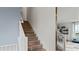 Elegant staircase with wood steps, white railings, and bright lighting at 15113 Grove Lake Dr, Winter Garden, FL 34787