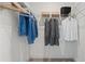 A walk-in closet featuring metal shelving, hanging rods, and ample storage space for clothing and accessories at 15113 Grove Lake Dr, Winter Garden, FL 34787