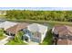 Aerial view of a two-story home with a gray roof and a pond in the backyard at 3189 Kearns Rd, Mulberry, FL 33860