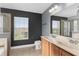 Bathroom with large vanity, toilet, shower and tub with a big window view at 3189 Kearns Rd, Mulberry, FL 33860