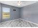 Bedroom featuring a ceiling fan, grey walls, and a big window at 3189 Kearns Rd, Mulberry, FL 33860