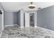 Spacious bedroom with marble-look tile floor, and modern ceiling fan at 3189 Kearns Rd, Mulberry, FL 33860