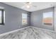 Bedroom with marble floors, neutral walls, two windows, and a ceiling fan at 3189 Kearns Rd, Mulberry, FL 33860