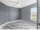 Bedroom featuring a window, grey walls, and marble-look tile floor at 3189 Kearns Rd, Mulberry, FL 33860