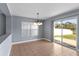 A dining room with pendant lighting and a sliding glass door leading to the backyard at 3189 Kearns Rd, Mulberry, FL 33860