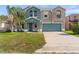 Two-story home featuring blue-gray exterior paint, well-manicured lawn and a two-car garage at 3189 Kearns Rd, Mulberry, FL 33860