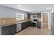 Kitchen with stainless steel appliances, tile backsplash and gray cabinets at 3189 Kearns Rd, Mulberry, FL 33860