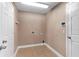 A cozy laundry room with neutral walls and tile flooring at 3189 Kearns Rd, Mulberry, FL 33860