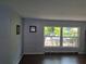 Living room featuring a large window and dark hardwood floors at 1000 Andrea Ridge Ct, Kissimmee, FL 34747