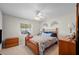 Cozy bedroom featuring a wooden bed frame and natural light from the window at 119 Lake Mariam Way, Winter Haven, FL 33884