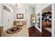 Bright foyer with tile flooring, a decorative mirror, and an arched doorway at 119 Lake Mariam Way, Winter Haven, FL 33884