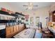 Cozy home office featuring built-in shelving, a ceiling fan, and French doors leading to the outdoors at 119 Lake Mariam Way, Winter Haven, FL 33884