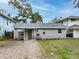 Charming single-story home featuring a gravel driveway and freshly painted siding at 5125 Isabelle Ave, Port Orange, FL 32127