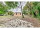 Rear view of home featuring a yard with trees at 824 Interlake Dr, Lakeland, FL 33801