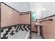 Retro bathroom featuring colorful tiling, vanity with sink, and shower/tub combo at 824 Interlake Dr, Lakeland, FL 33801