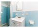 Clean bathroom featuring a shower stall and single sink vanity with blue tile surround at 824 Interlake Dr, Lakeland, FL 33801