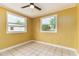 Bright bedroom with paneled walls, tile floors, and large windows at 824 Interlake Dr, Lakeland, FL 33801