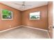 Bright bedroom featuring tile floors, neutral walls, and a ceiling fan at 824 Interlake Dr, Lakeland, FL 33801