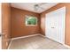 Bedroom with ceiling fan, tile flooring, and closet at 824 Interlake Dr, Lakeland, FL 33801