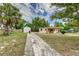 Exterior view showing the house, driveway, and additional structure on the property at 824 Interlake Dr, Lakeland, FL 33801