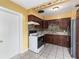 The kitchen features wood cabinetry, tile backsplash, and white appliances at 824 Interlake Dr, Lakeland, FL 33801