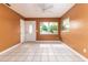 Bright living room with tile floors, ceiling fan, and a large window at 824 Interlake Dr, Lakeland, FL 33801