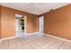 Open-concept living area featuring neutral tile flooring and ample natural light at 824 Interlake Dr, Lakeland, FL 33801