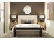 Well-lit bedroom with dark wood accents and elegant, symmetrical bedside lamps at 1178 Hour Glass Rd, Lakeland, FL 33801