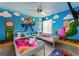 Fun themed bedroom with colorful murals, twin beds, and playful decor, perfect for and gaming enthusiasts at 5012 Laguna Bay Cir # 72, Kissimmee, FL 34746
