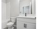 Bathroom features a shower-tub combo, white cabinets, and chrome fixtures at 6057 Sacred Oak Ave, Mount Dora, FL 32757