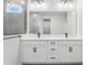 Bathroom features a double sink, undermount lighting, and windowed shower at 6057 Sacred Oak Ave, Mount Dora, FL 32757