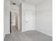 Neutral bedroom features gray carpet, white walls and trim, and an ensuite bathroom at 6057 Sacred Oak Ave, Mount Dora, FL 32757