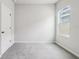 Bedroom with neutral colored carpet, and window at 6057 Sacred Oak Ave, Mount Dora, FL 32757