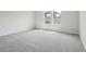 Bright bedroom featuring two windows and neutral carpet at 6057 Sacred Oak Ave, Mount Dora, FL 32757