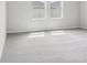 Bright bedroom featuring two windows and neutral carpet at 6057 Sacred Oak Ave, Mount Dora, FL 32757