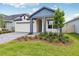 Beautiful home with a well-manicured lawn and landscaping, complemented by a charming blue accent at 6057 Sacred Oak Ave, Mount Dora, FL 32757
