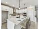 Bright kitchen features an island with bar seating, pendant lighting, and stainless steel appliances at 6057 Sacred Oak Ave, Mount Dora, FL 32757