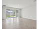 Open living room with sliding glass doors providing backyard access and natural light at 6057 Sacred Oak Ave, Mount Dora, FL 32757