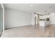 Open concept living space showcasing kitchen with a large island and neutral color palette at 6057 Sacred Oak Ave, Mount Dora, FL 32757