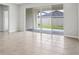 Spacious living room with sliding glass doors that lead to the backyard and patio at 6057 Sacred Oak Ave, Mount Dora, FL 32757