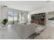 Open-concept living room with sliding glass doors to the backyard and a built-in entertainment center at 6057 Sacred Oak Ave, Mount Dora, FL 32757