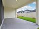 Covered patio overlooking a well-maintained lawn and fenced yard at 6057 Sacred Oak Ave, Mount Dora, FL 32757