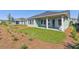 Backyard featuring the home's covered patio, green grass, and simple landscaping at 6221 Trailblaze Bnd, St Cloud, FL 34771