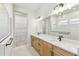 Modern bathroom showcasing a double sink vanity, large mirror, and access to a walk-in closet at 6221 Trailblaze Bnd, St Cloud, FL 34771