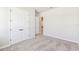 An airy bedroom boasts soft gray carpet, light-toned walls, and double doors leading to a closet at 6221 Trailblaze Bnd, St Cloud, FL 34771