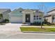 Charming single-Gathering home featuring a two car garage, manicured lawn, and a welcoming front porch at 6221 Trailblaze Bnd, St Cloud, FL 34771