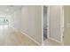 Bright hallway with light wood floors, leading to various rooms and ample natural light at 6221 Trailblaze Bnd, St Cloud, FL 34771