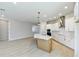 Open-concept kitchen with island, stainless hood vent, and eat-in space at 6221 Trailblaze Bnd, St Cloud, FL 34771